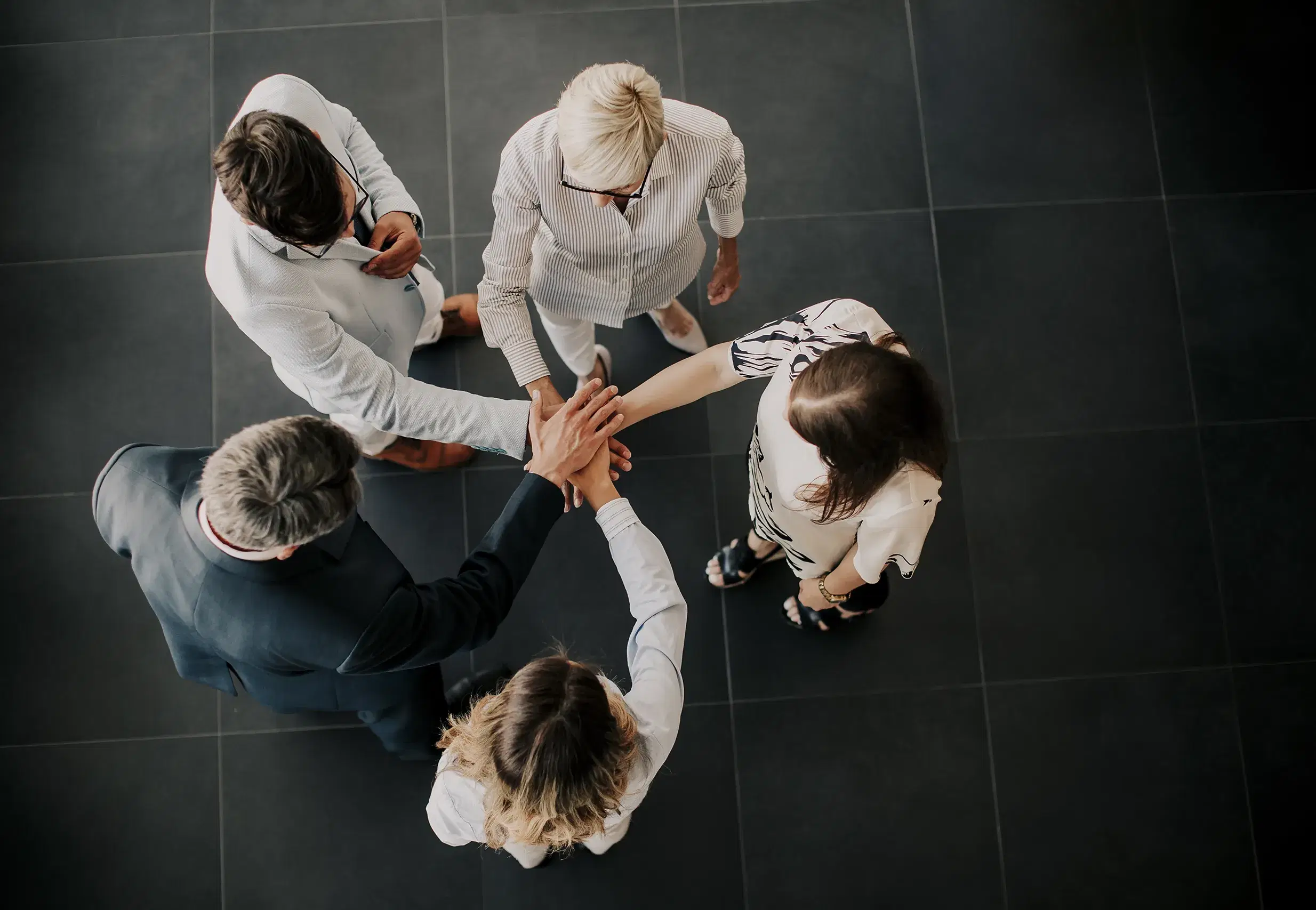 view-group-business-people-holding-hands-together copy